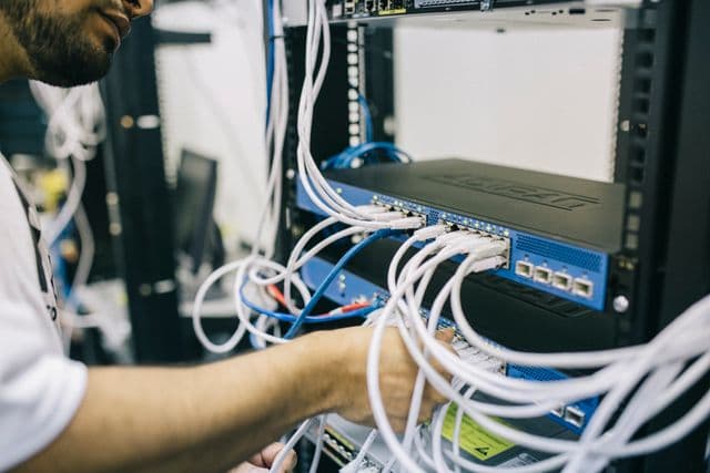 Technician installing educational technology equipment